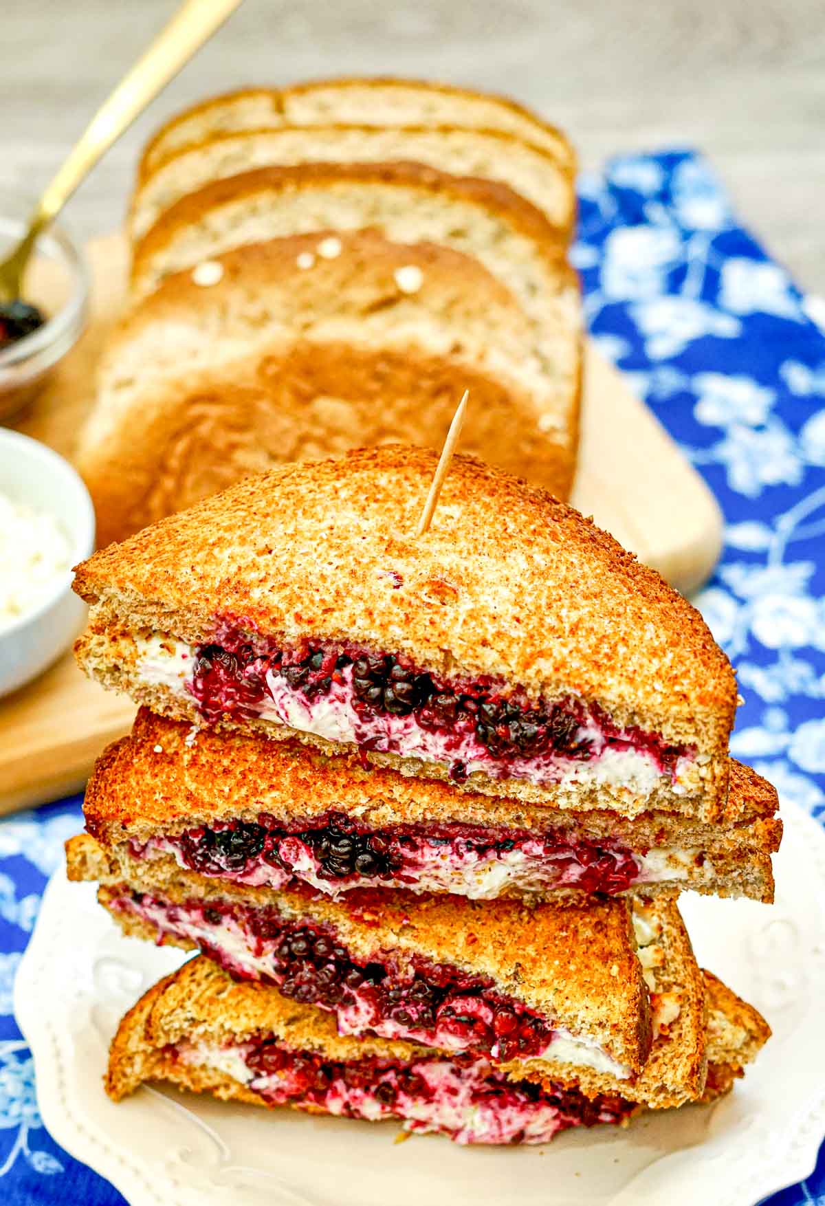 Blackberry goat cheese grilled cheese sandwich triangles on a plate