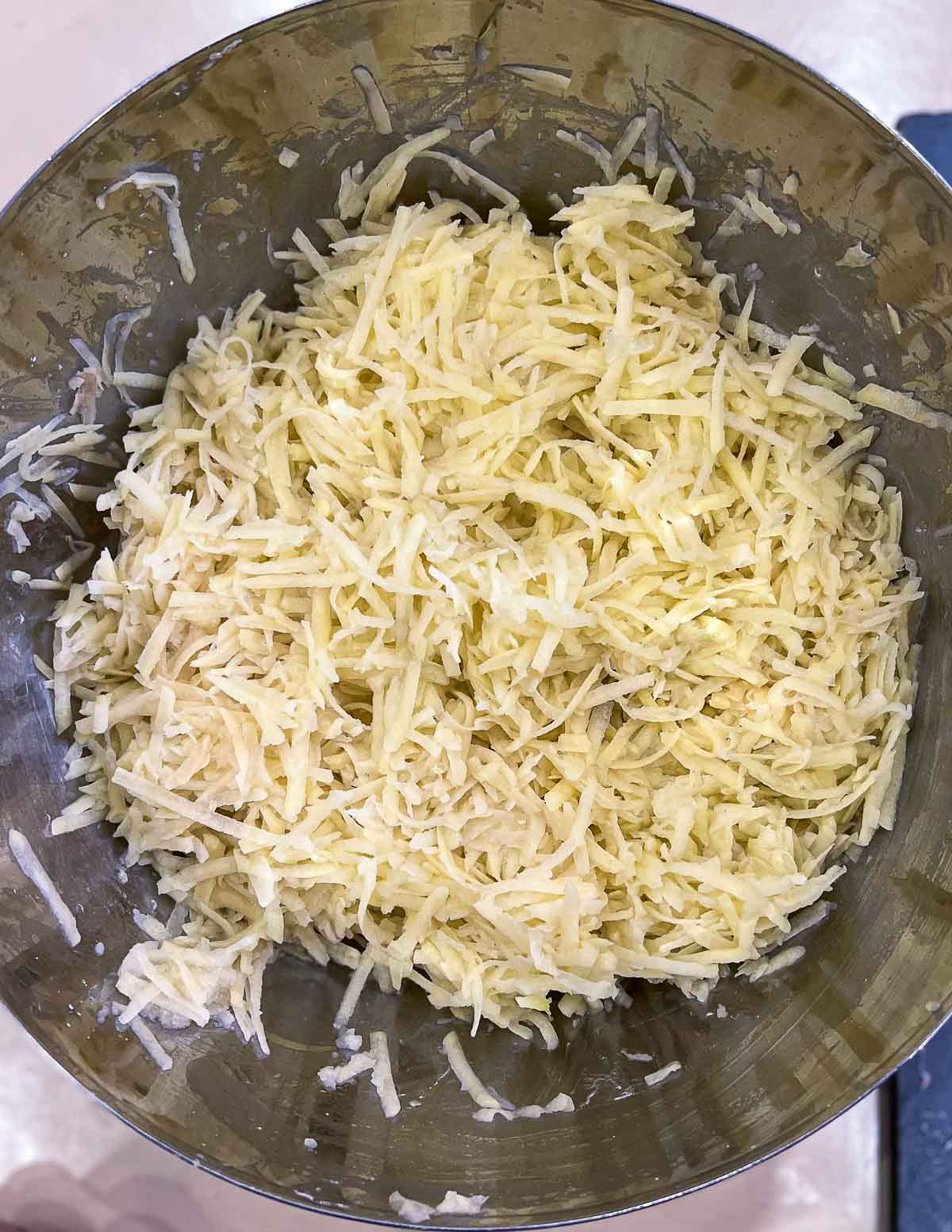 Grated potatoes in a bowl.