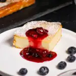 Slice of zapekanka topped with berry sauce