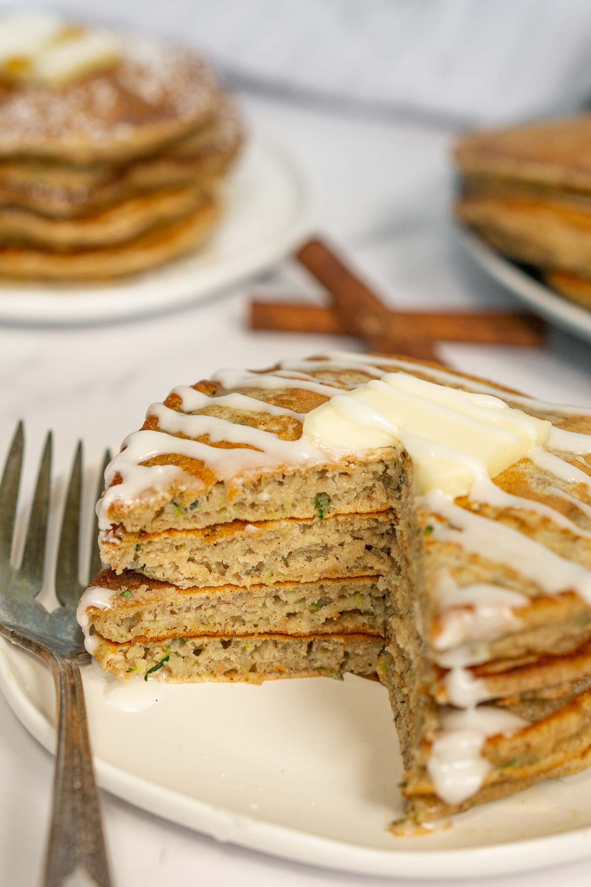 Plate of zucchini bread pancakes cut open to show texture inside.