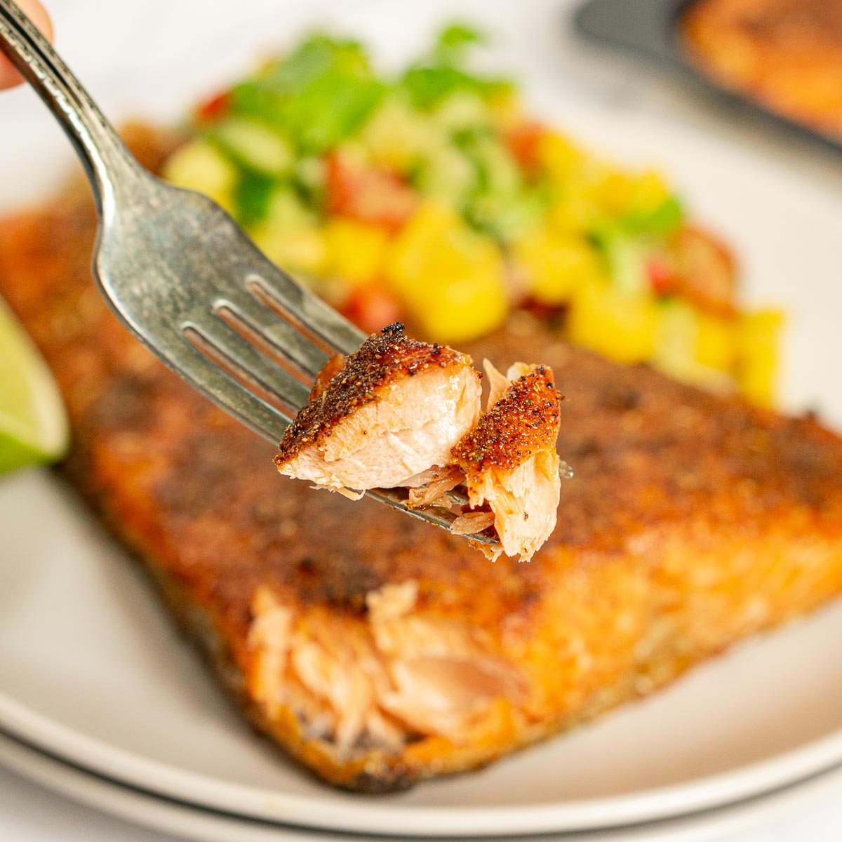 Fork showing how flaky air fryer trout is
