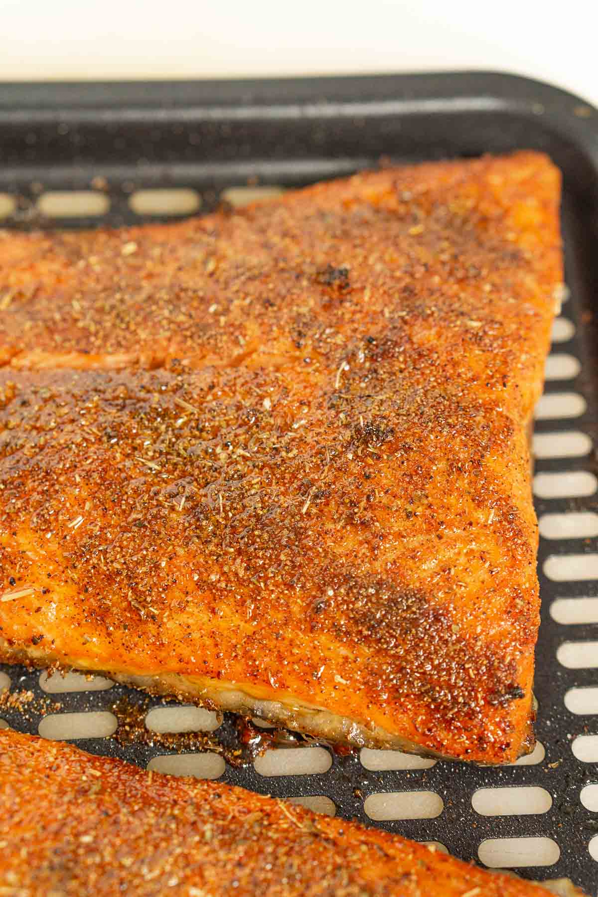 Cooked trout in an air fryer tray
