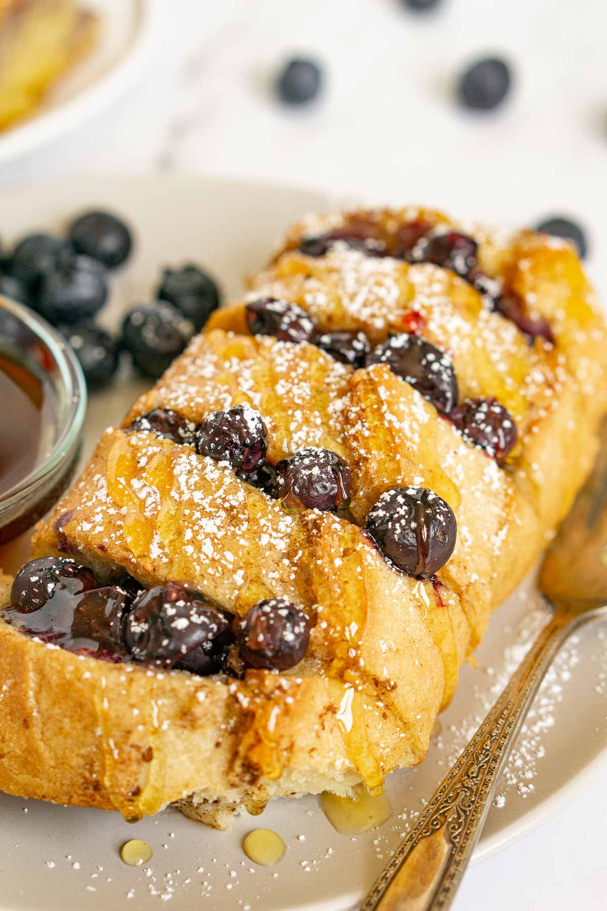Close up of baked Hasselback French Toast with blueberries