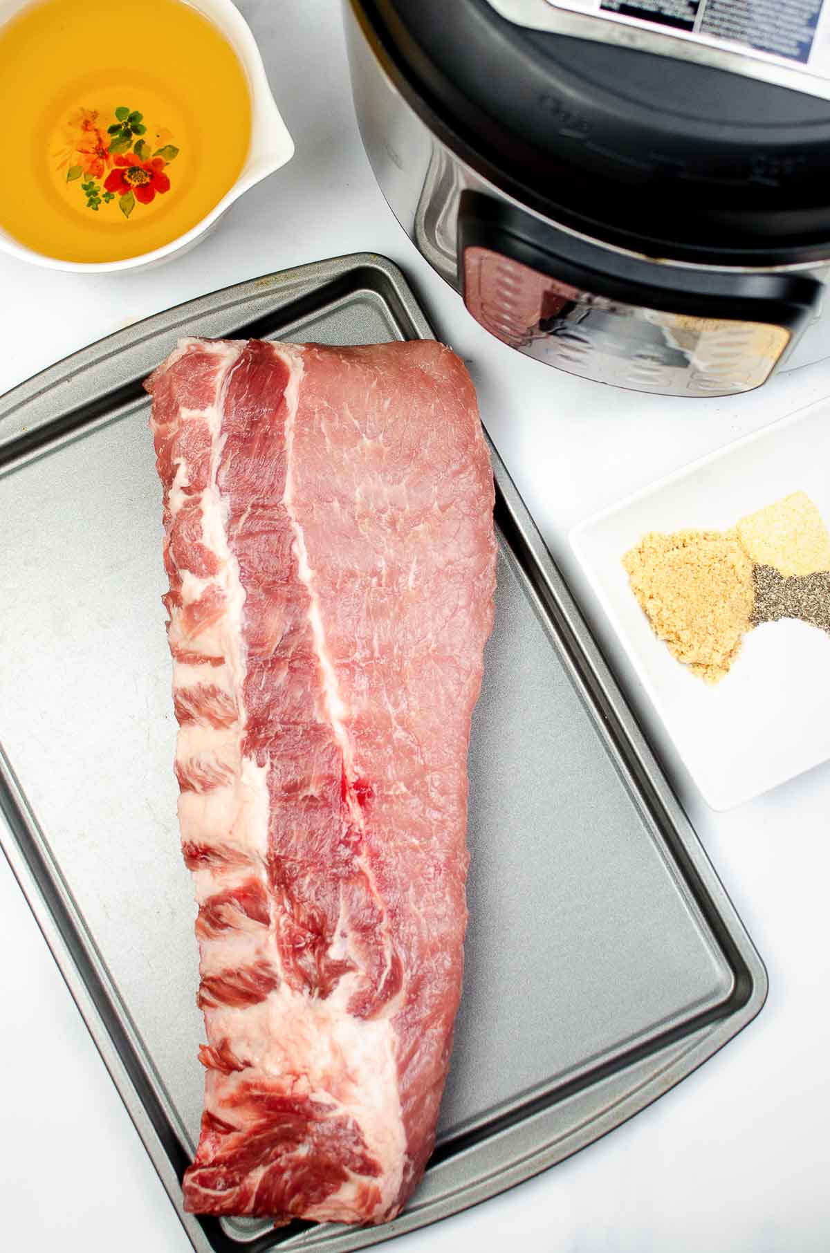 baby back ribs and ingredients next to an Instant Pot