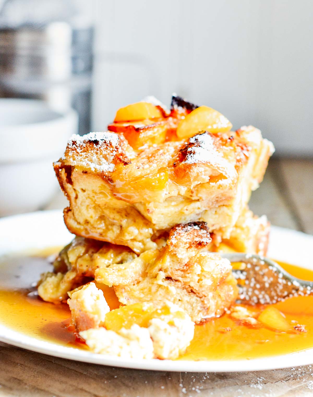 Plate of Peach French Toast Casserole with maple syrup