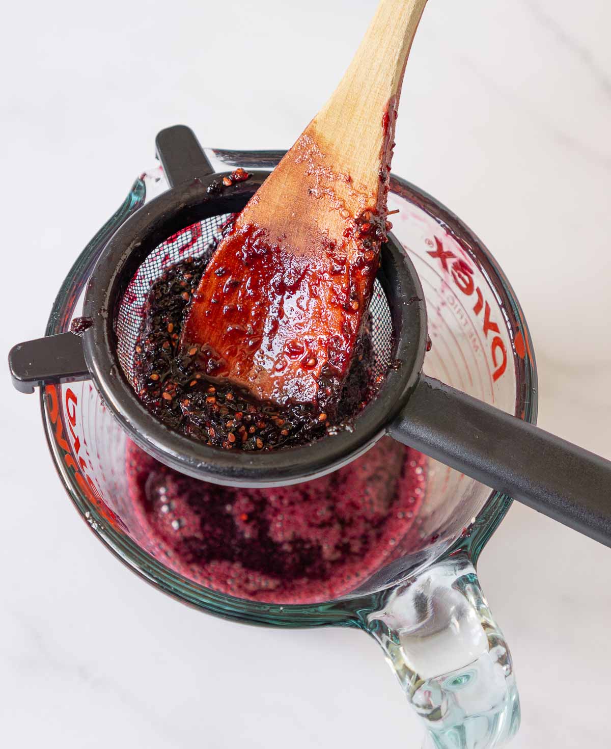 Pushing mulberry syrup through a sieve