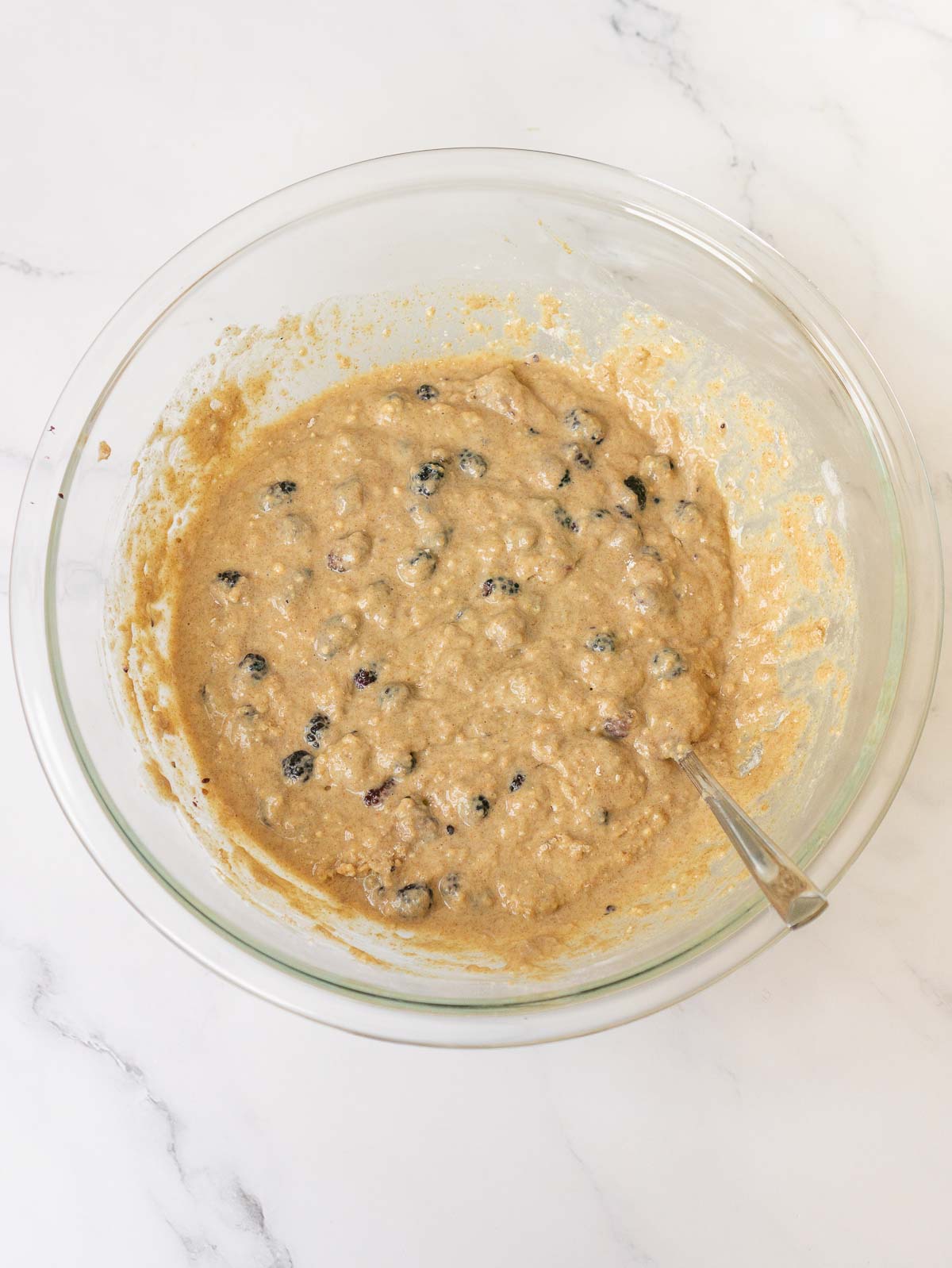 Mulberry muffin batter with fresh mulberries in a bowl