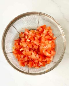 Diced tomatoes straining in a colander