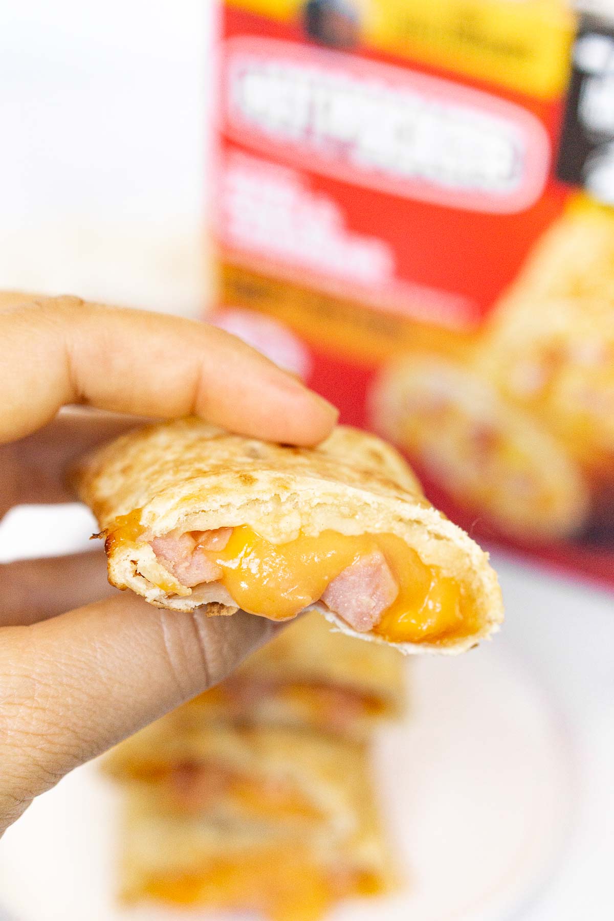 Hand showing inside of an air fried hot pocket