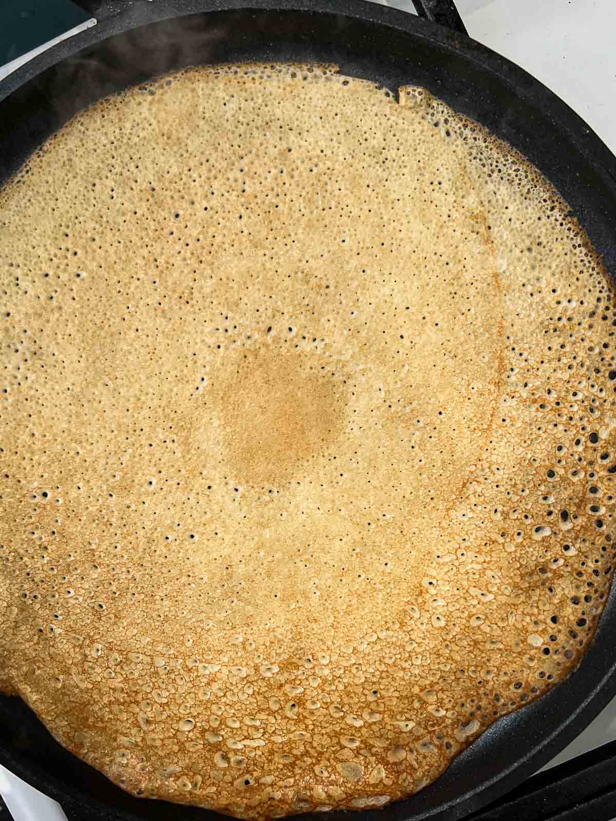 Crepe cooking in a pan