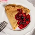 Buttermilk Crepes with berry compost on a plate