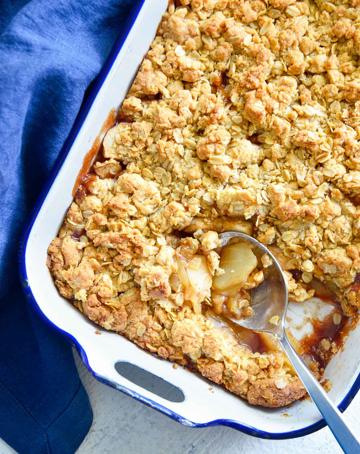 Dish or baked apple crisp with a spoon in it