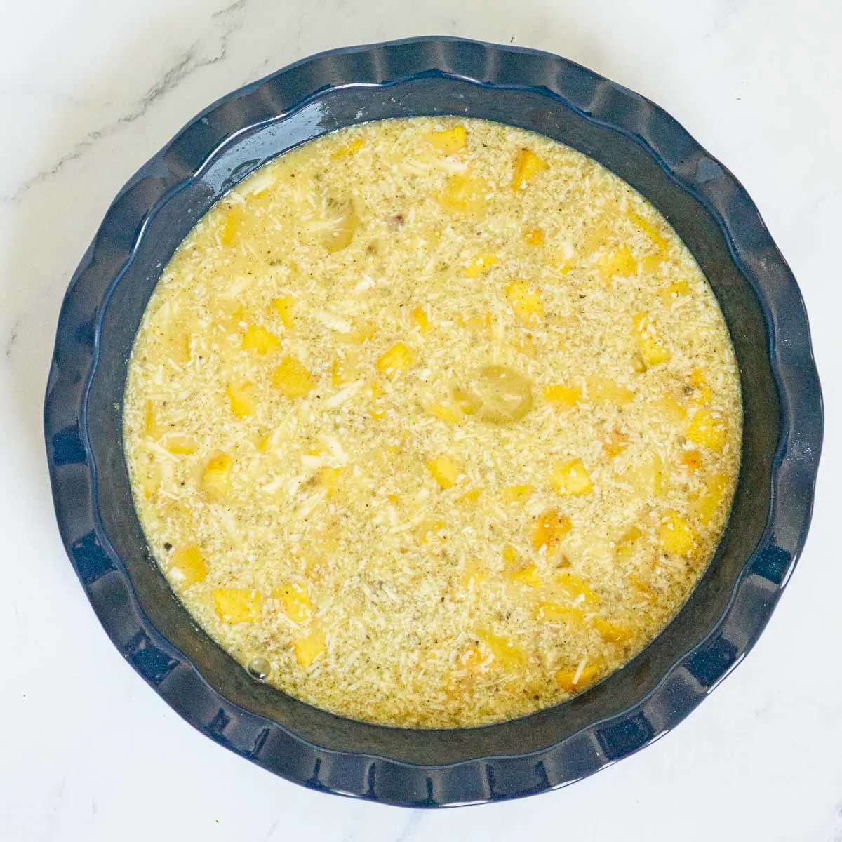 Egg and pumpkin mixture in a pie dish