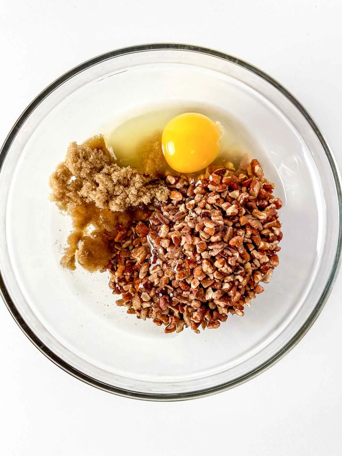 Bowl with pecans, sugar, egg, and corn syrup