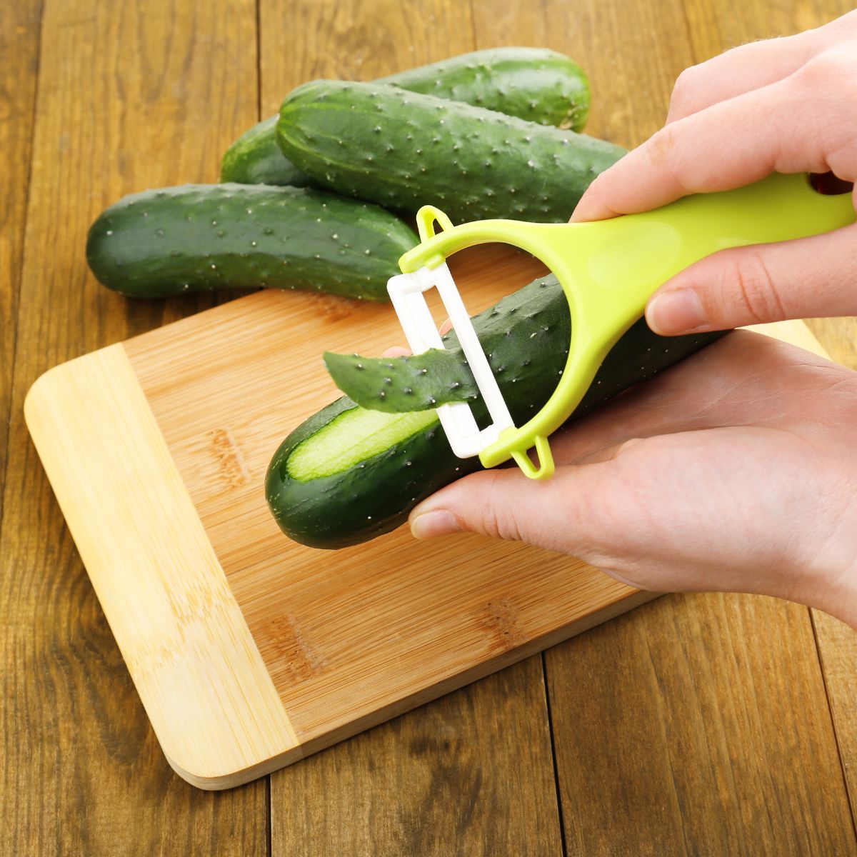 Peeling cucumber with a vegetable peeler