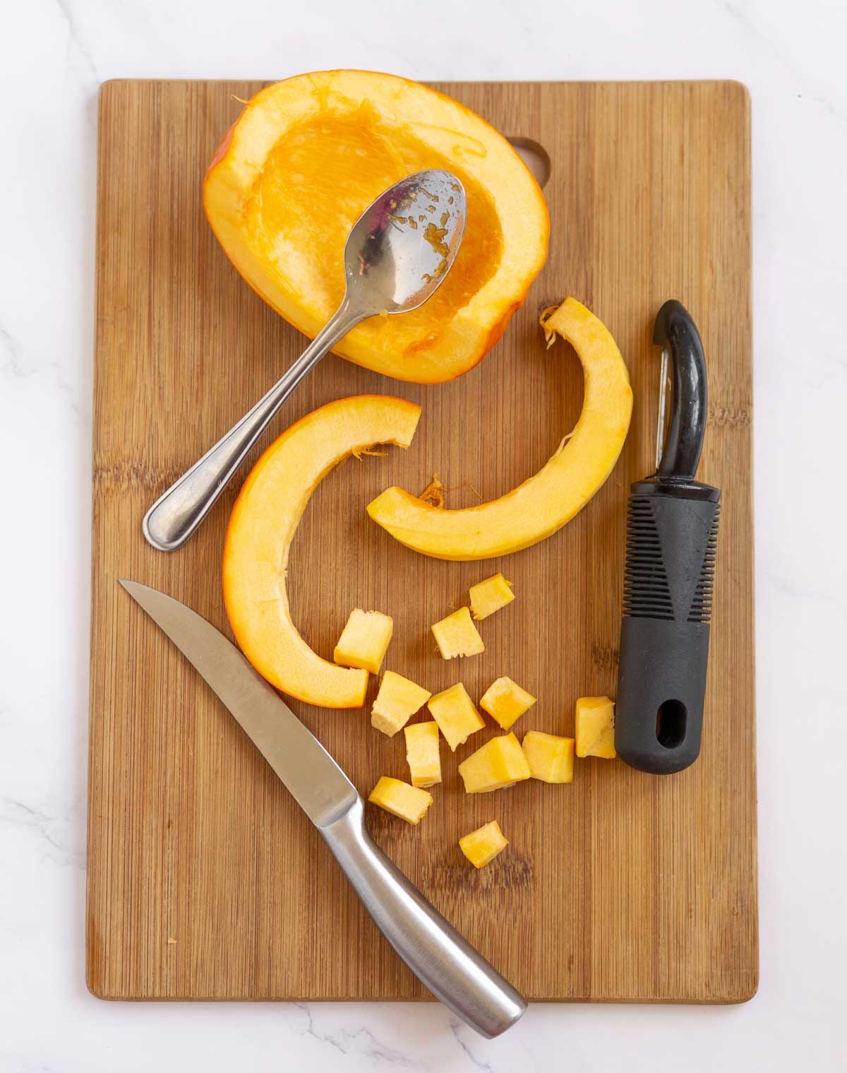Showing how to dice pumpkin on a cutting board