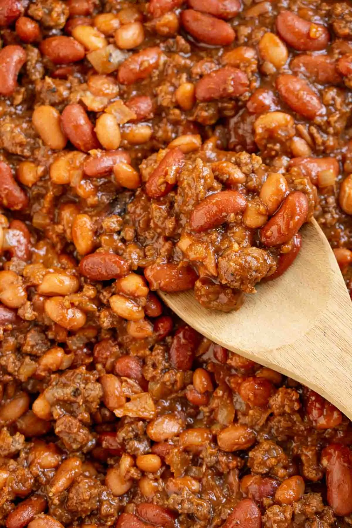 Closeup of thick baked beans with ground beef.