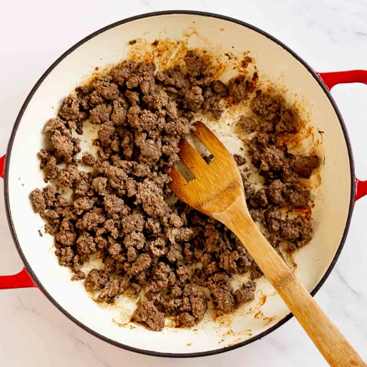 Cooked crumbled ground beef in a pan