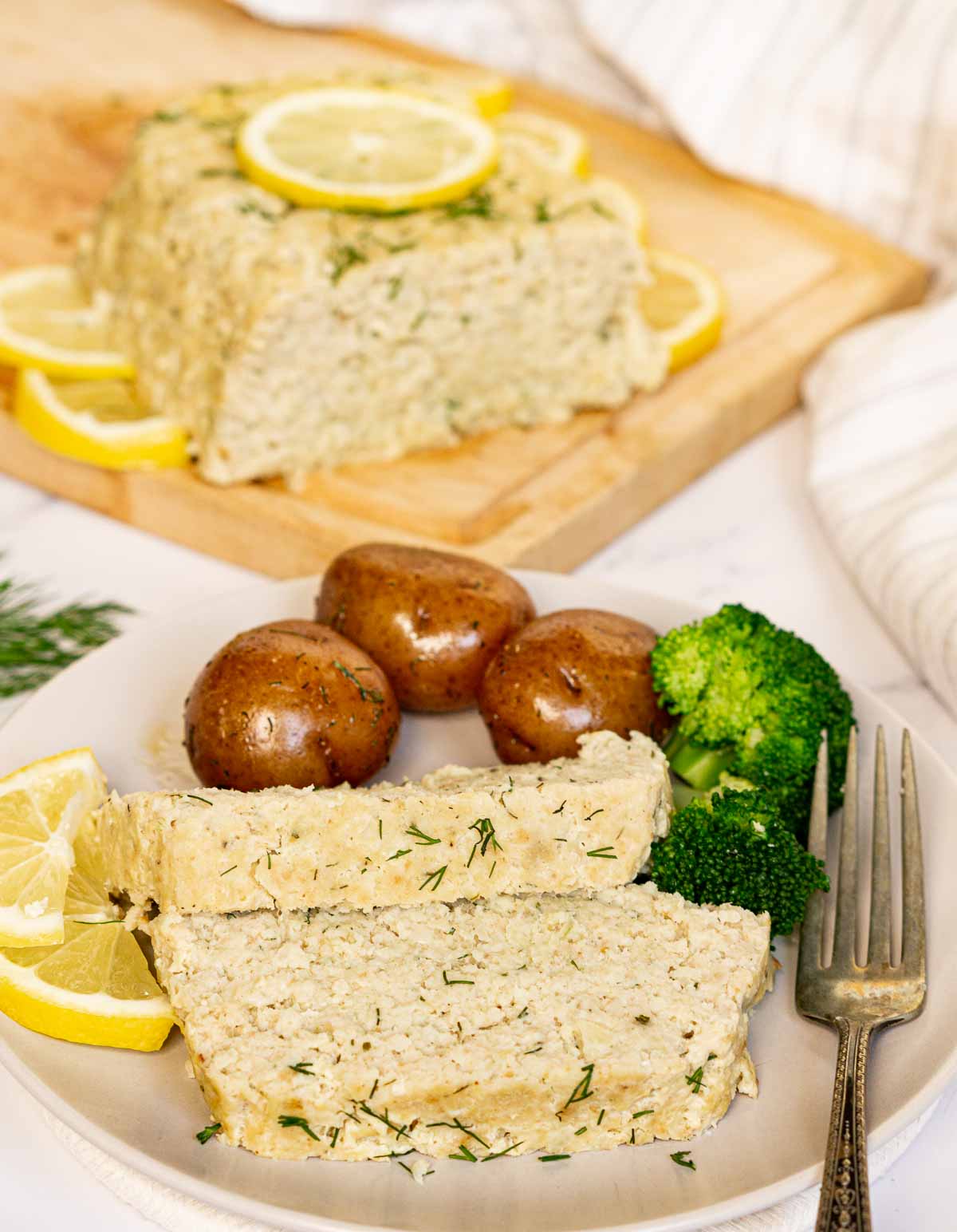 2 slices of fish loaf on a plate