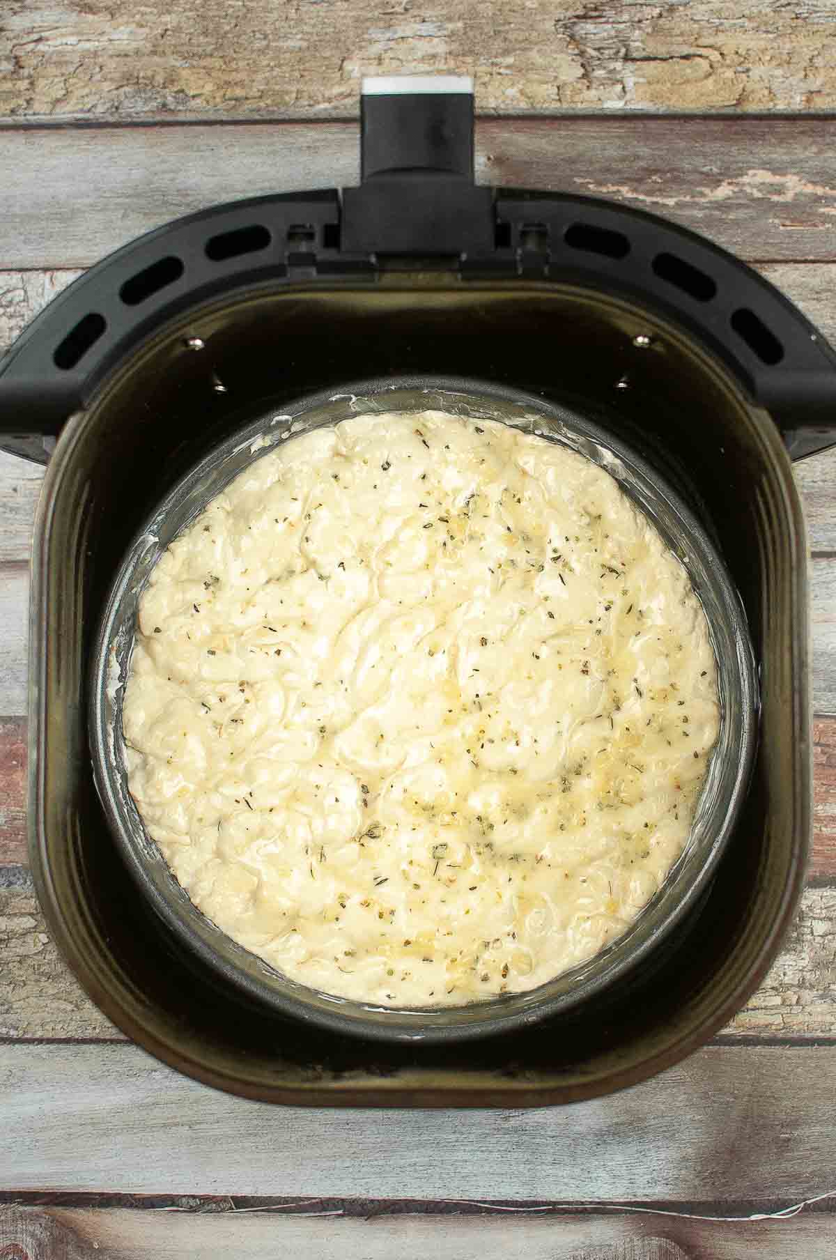 Pan of focaccia dough in the air fryer