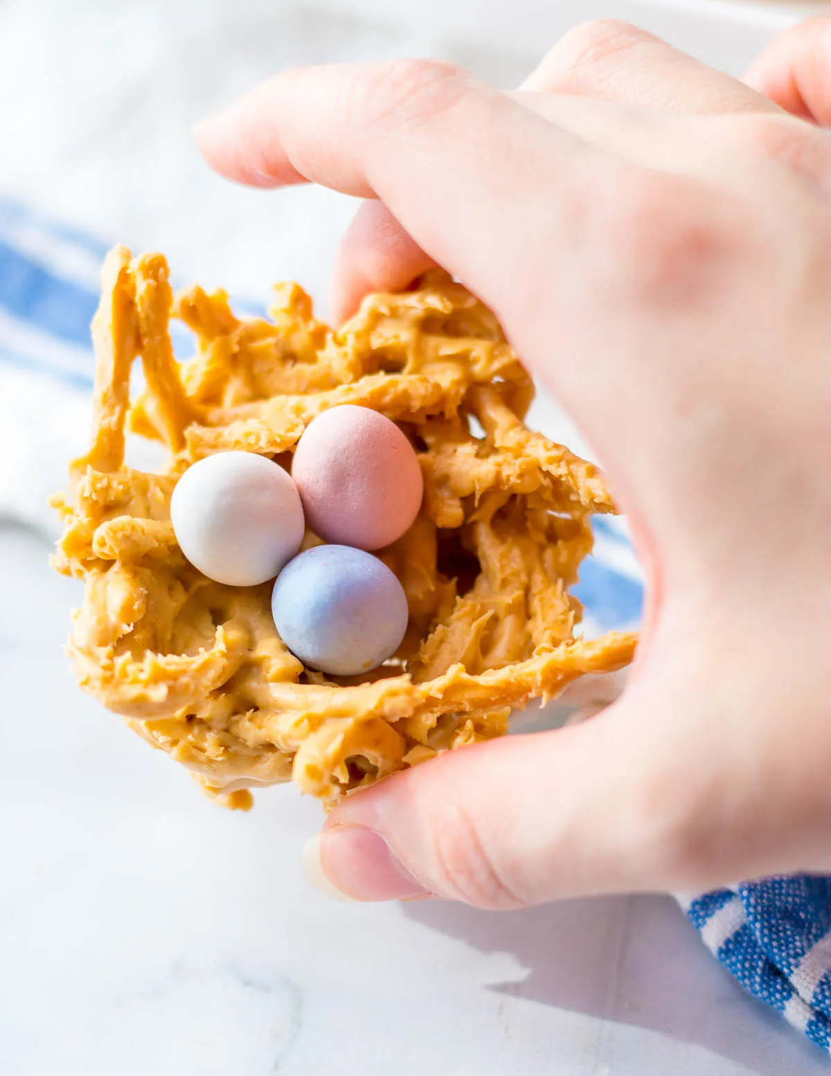 Hand holding Easter egg nest cookie