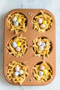 Muffin tin with no-bake Easter egg nest desserts