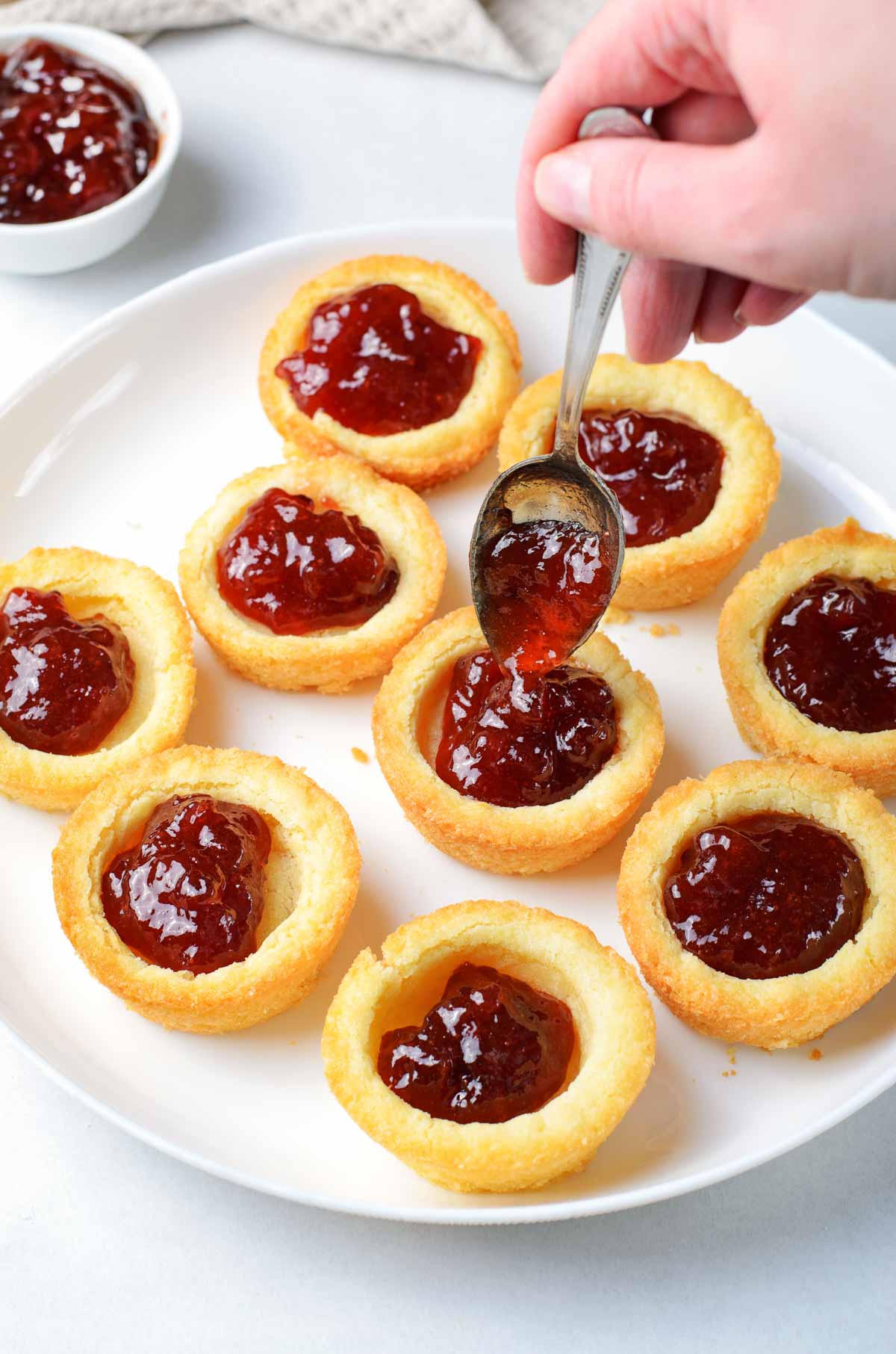 Sugar cookie cups filled with strawberry jam