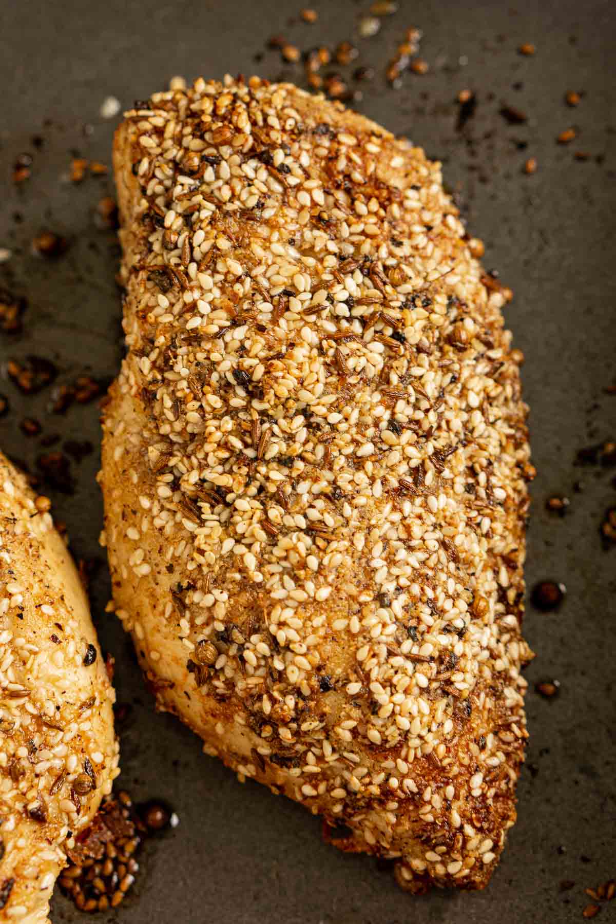 Dukkah crusted chicken on a baking pan