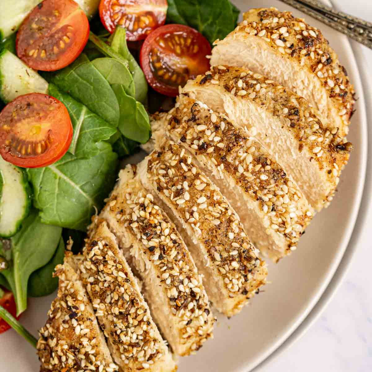 Dukkah chicken breast over a salad