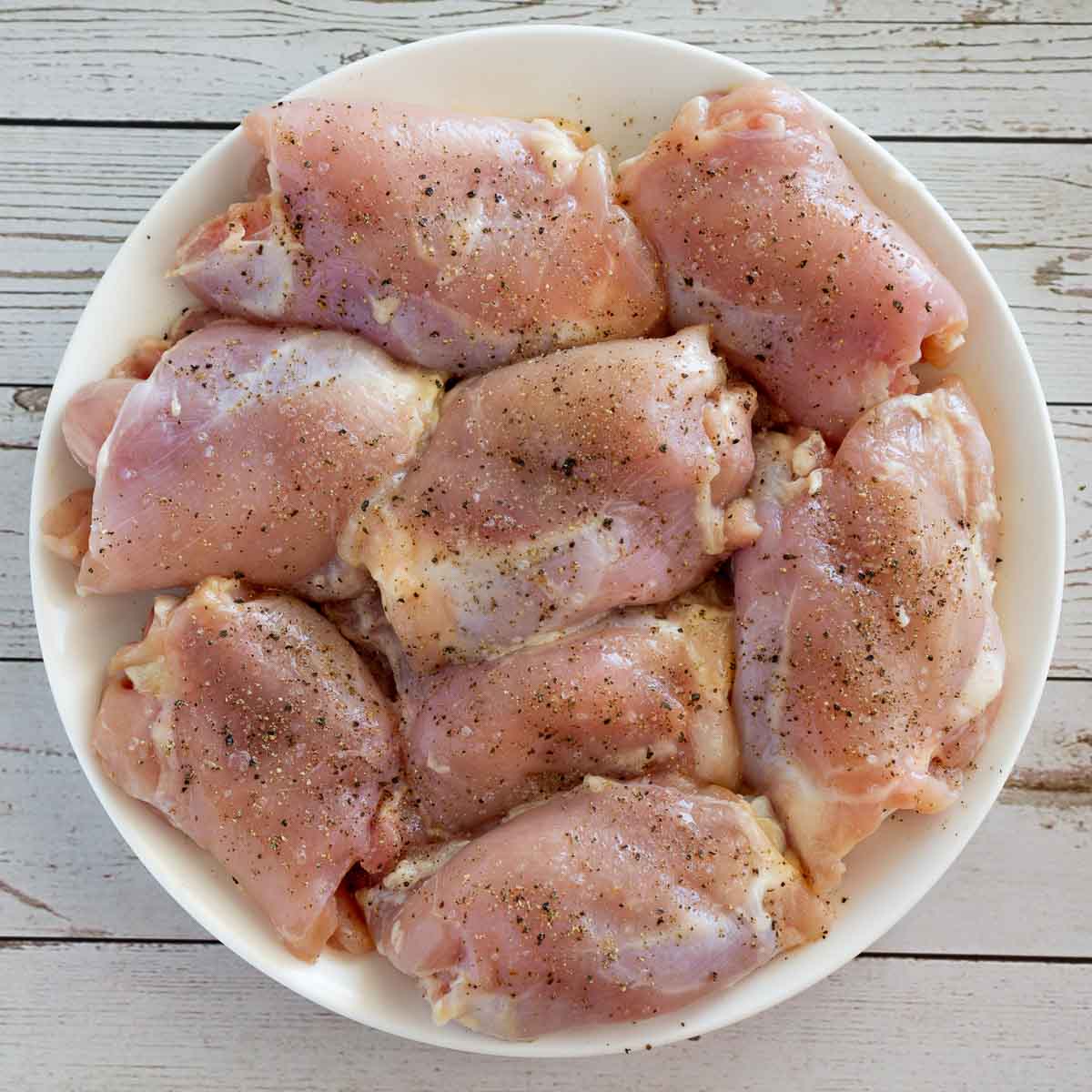 Plate of skinless boneless chicken thighs