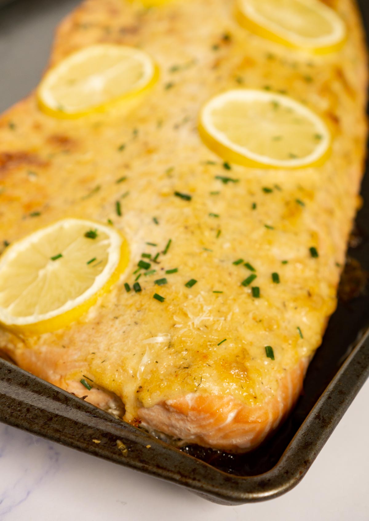 Close up of creamy baked salmon on a baking p