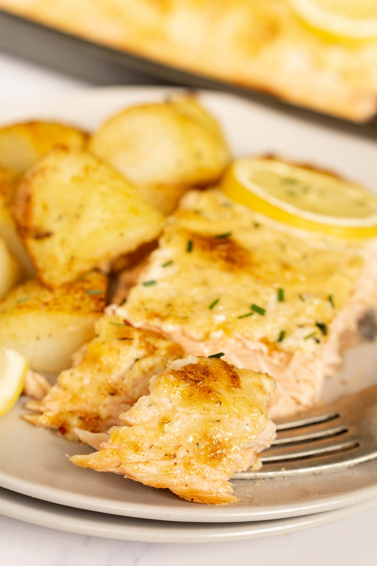 Mayo baked salmon on a plate with potatoes