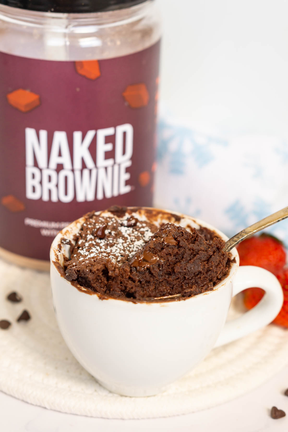 Protein mug brownie being picked up with a spoon to show fudgy texture