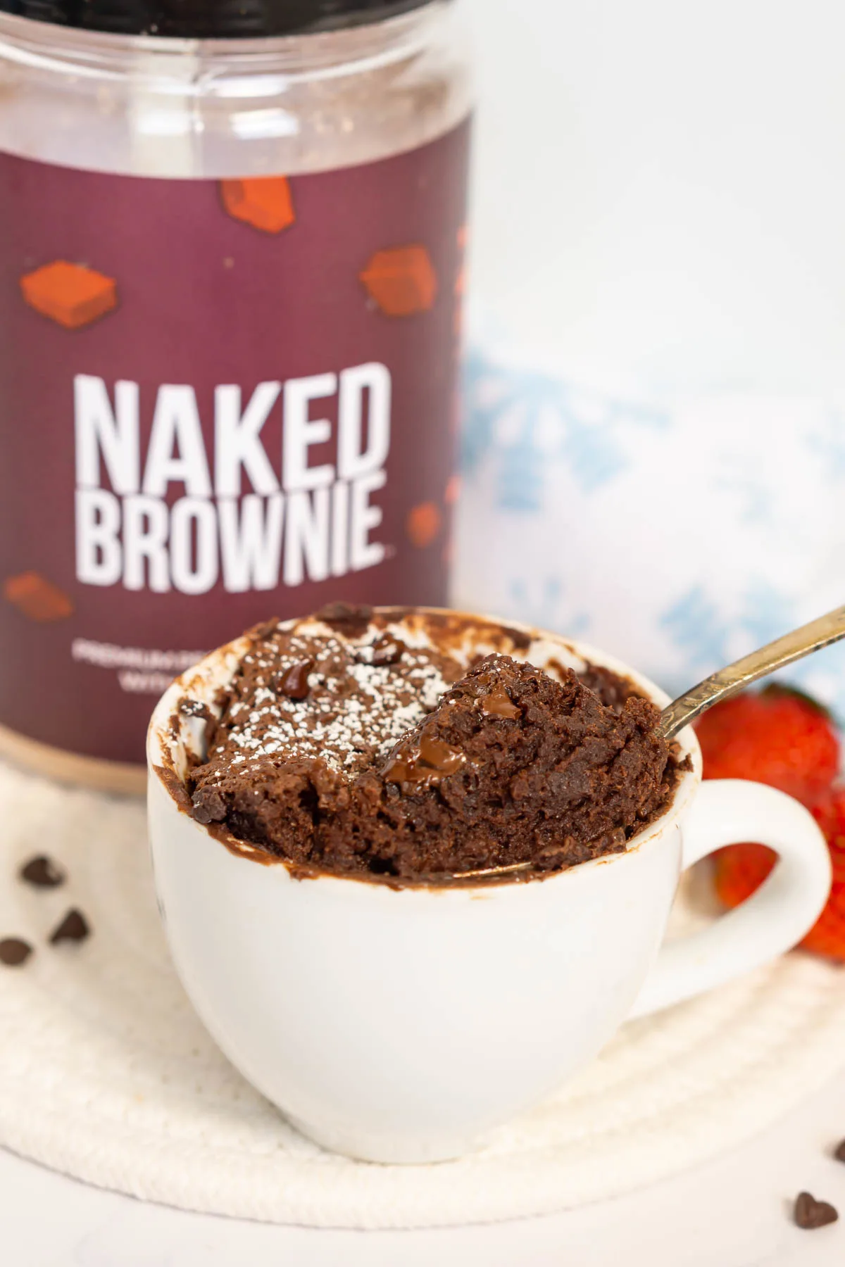 Protein mug brownie being picked up with a spoon to show fudgy texture