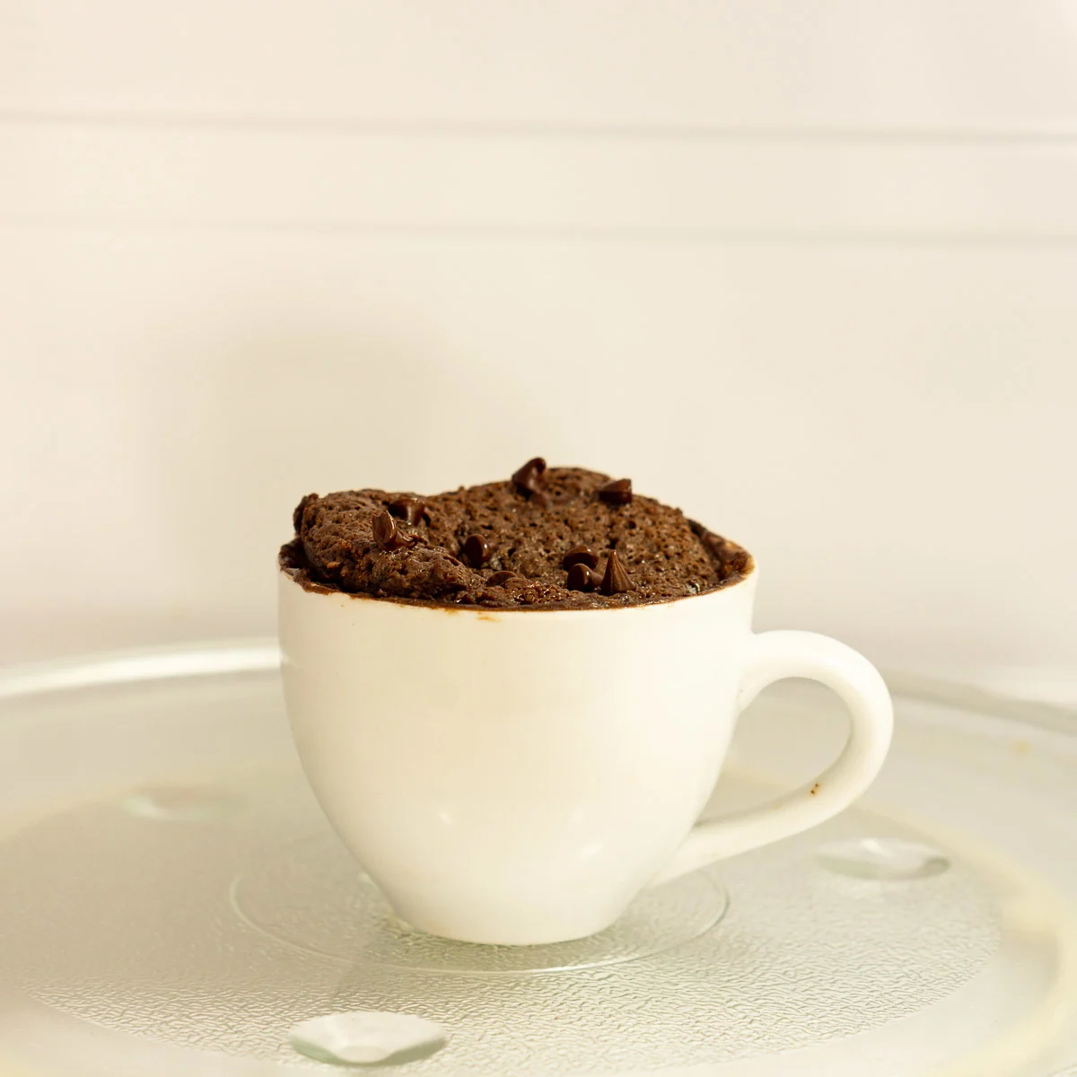 Protein brownie being cooked in a mug in the microwave