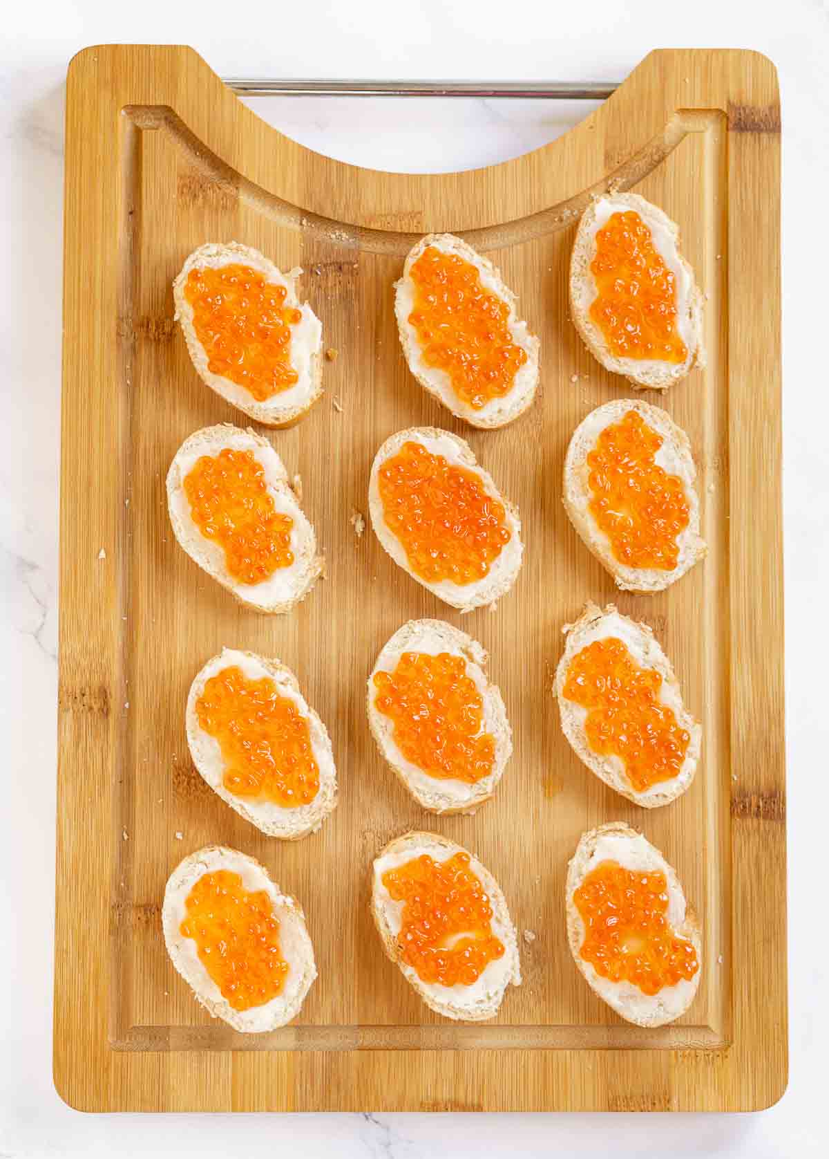Baguette slices topped with butter and salmon roe