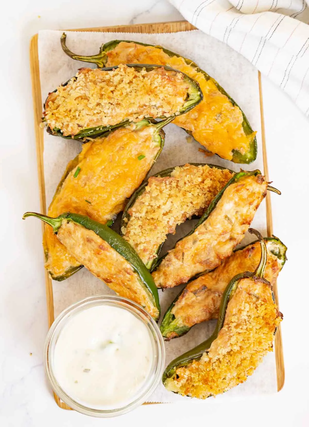 Tuna jalapeño poppers with different toppings on a serving board