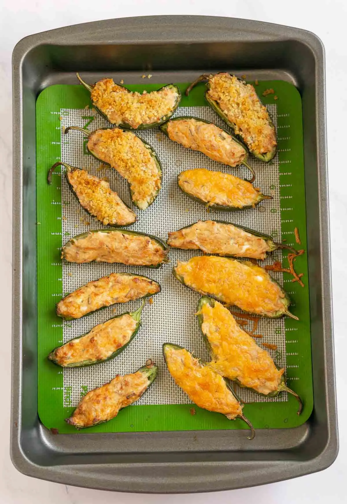 Baked tuna jalapeño poppers on a baking pan