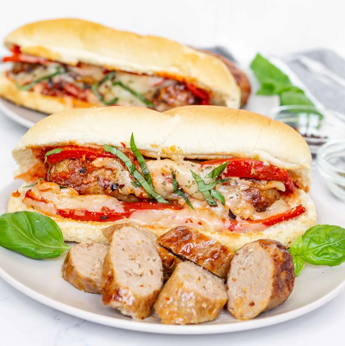 Air fried Italian sausages and sandwich on a plate