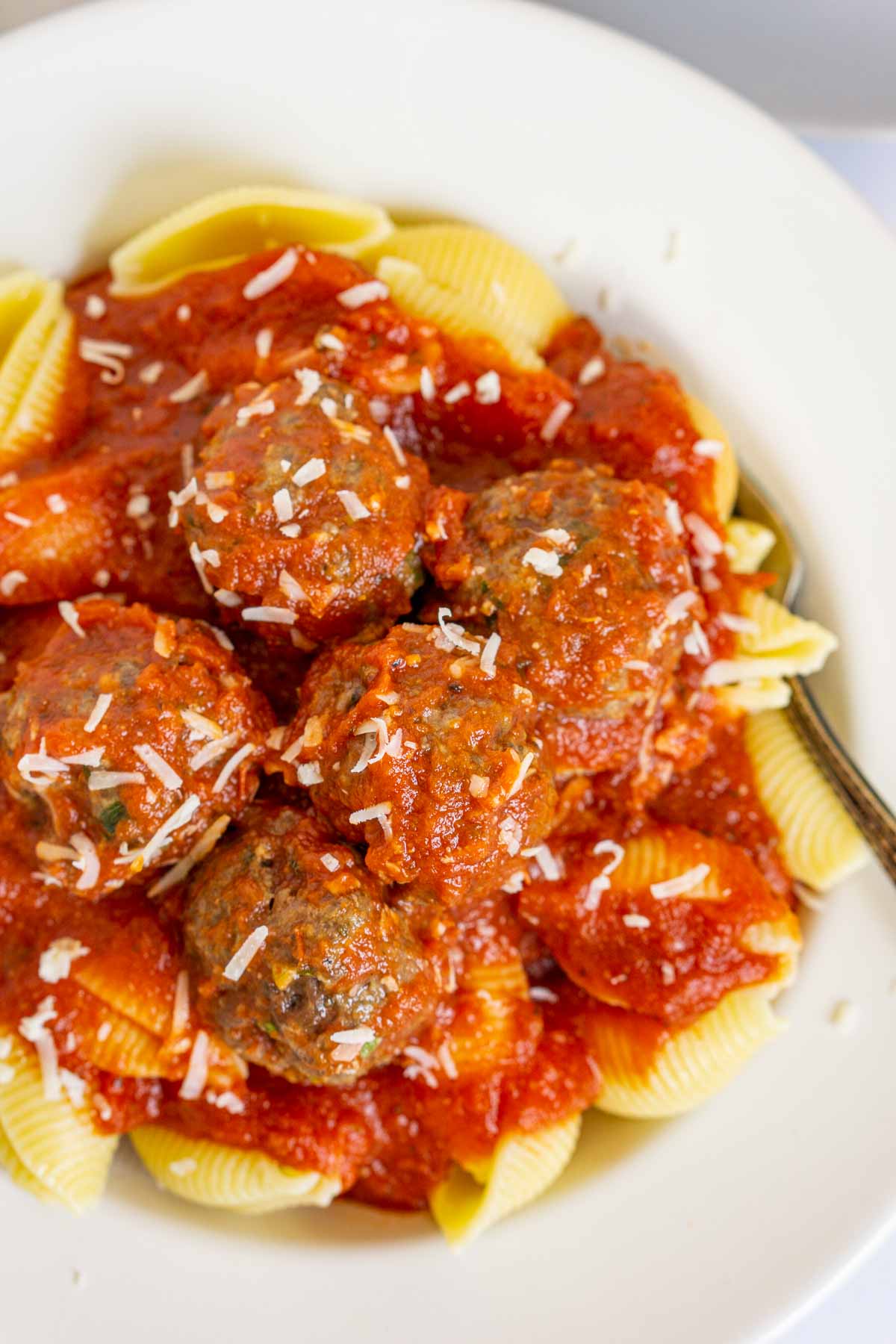 Plate of bison meatballs with marinara sauce over pasta