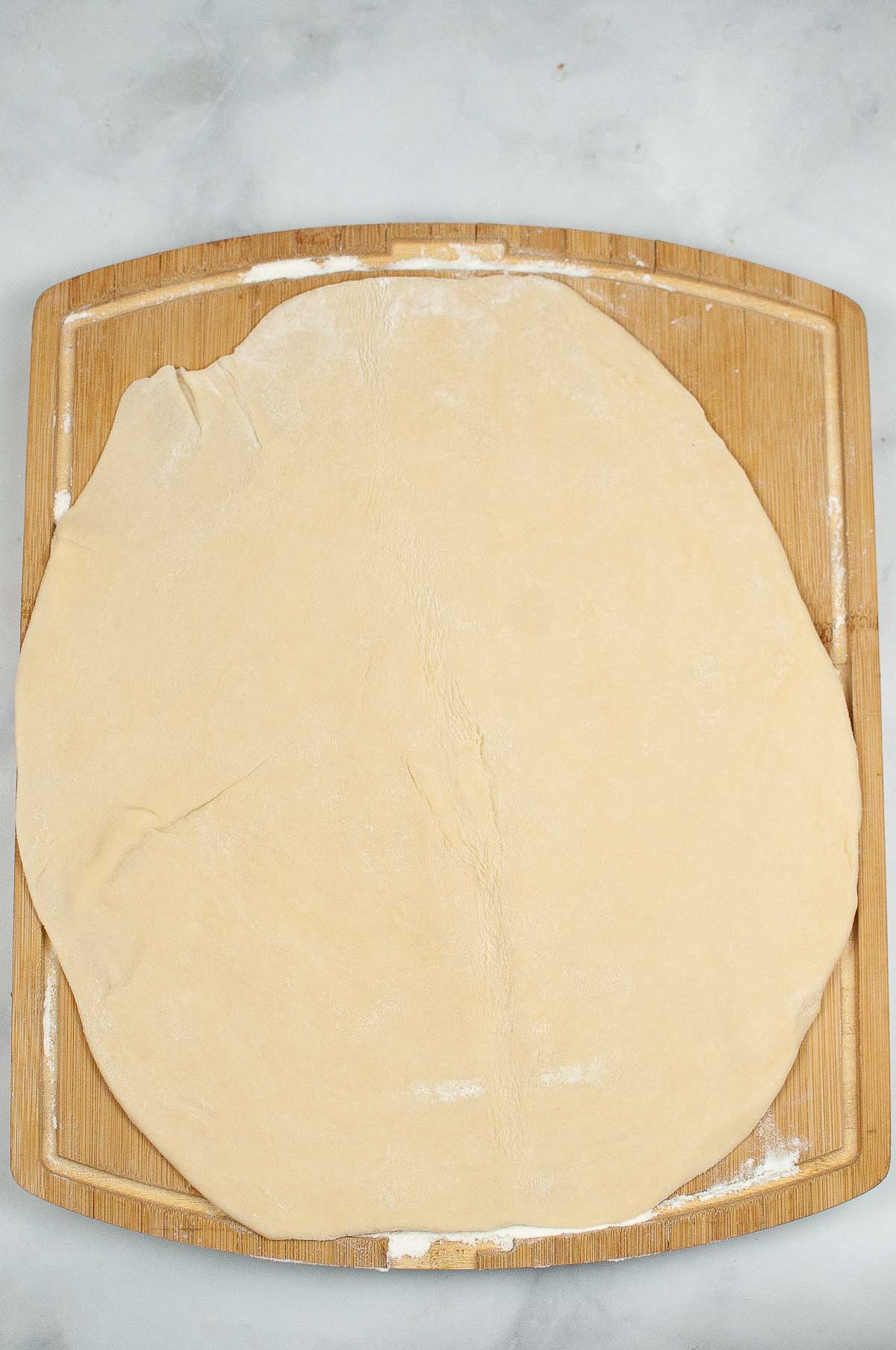 Rolled out pie crust on a cutting board