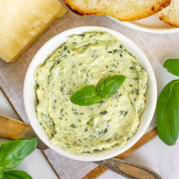 Close up of a container of pesto compound butter