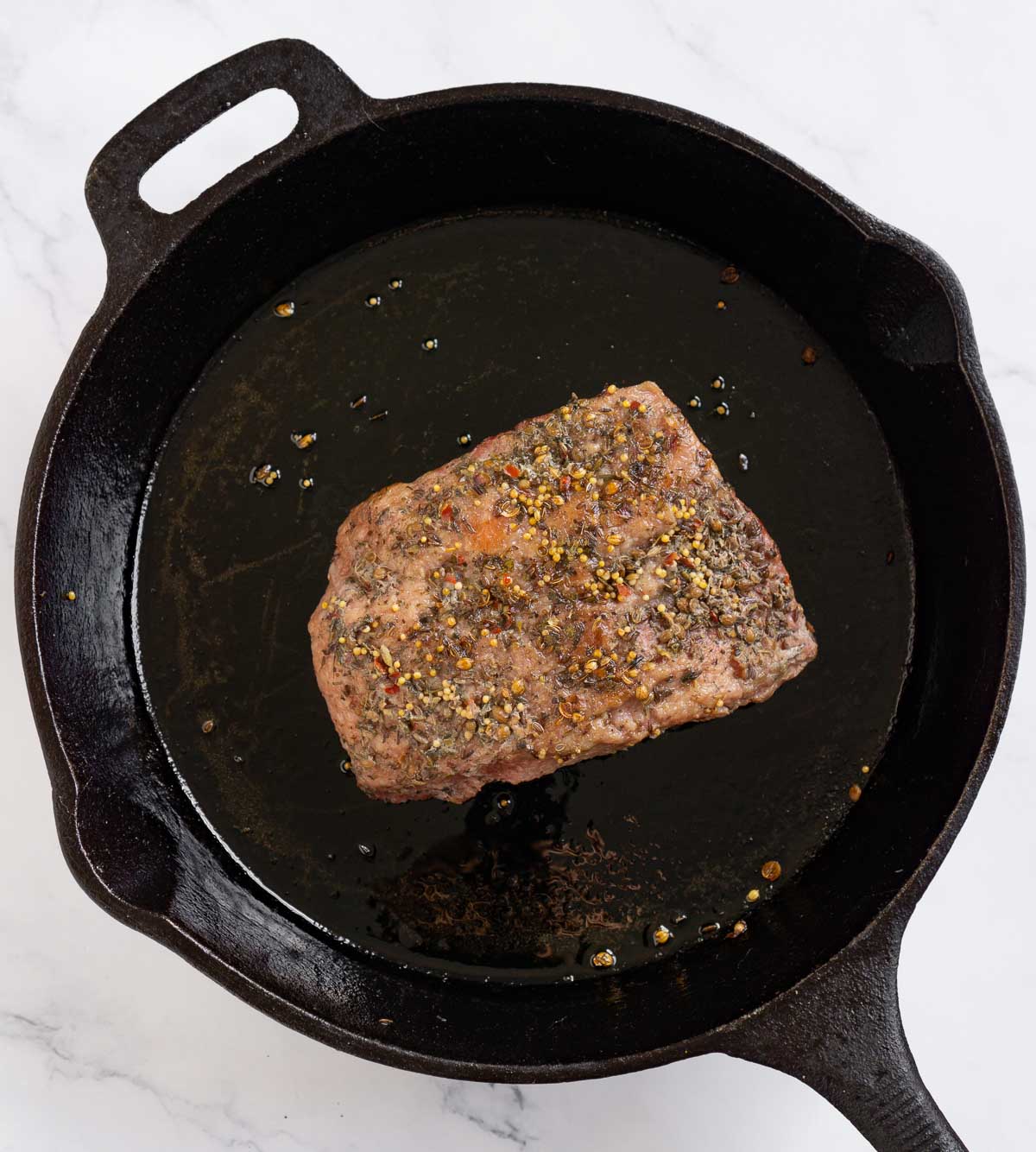 Browning a sous vide corned beef brisket in a skillet