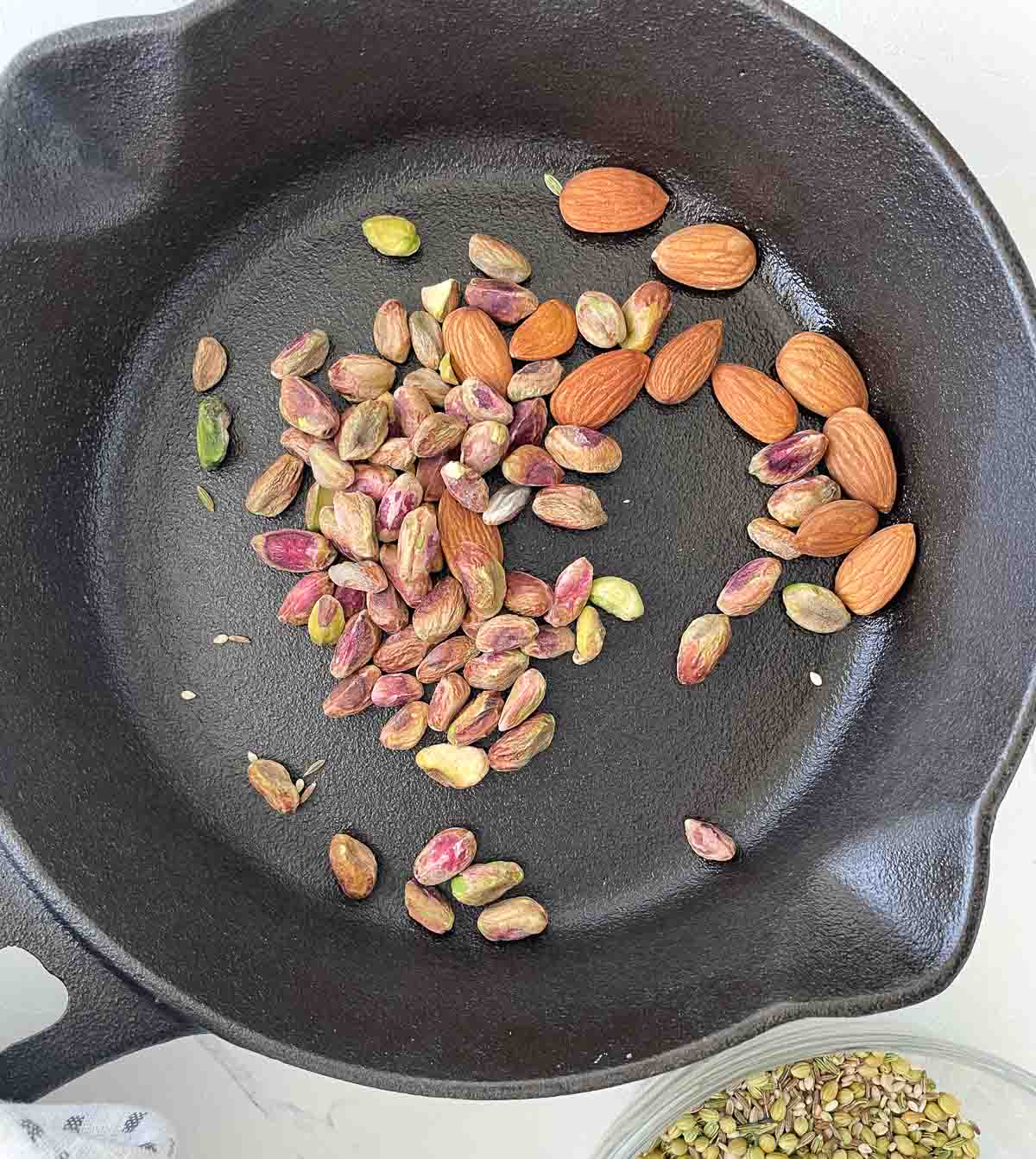 Toasting pistachios and almonds in a pan