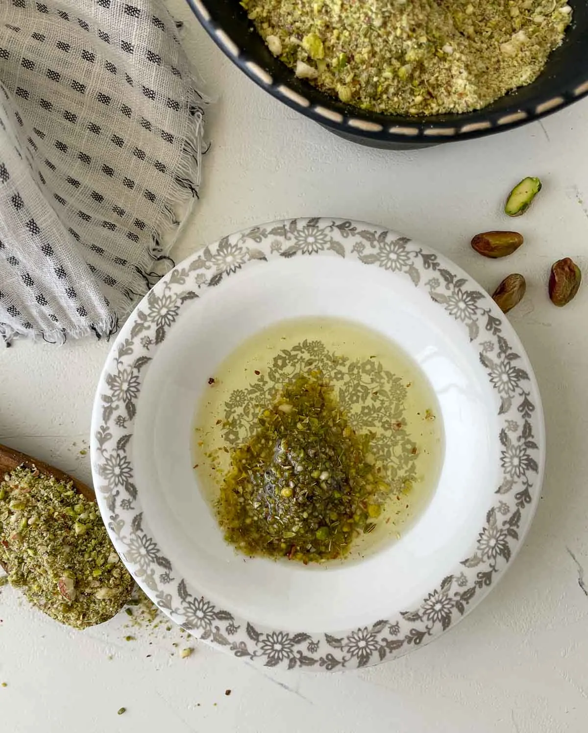 Dukkah seasoning in a bowl of olive oil