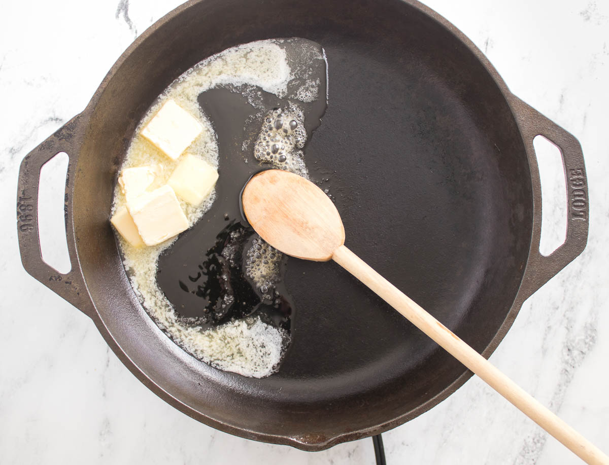 Butter and honey melting in a skillet.