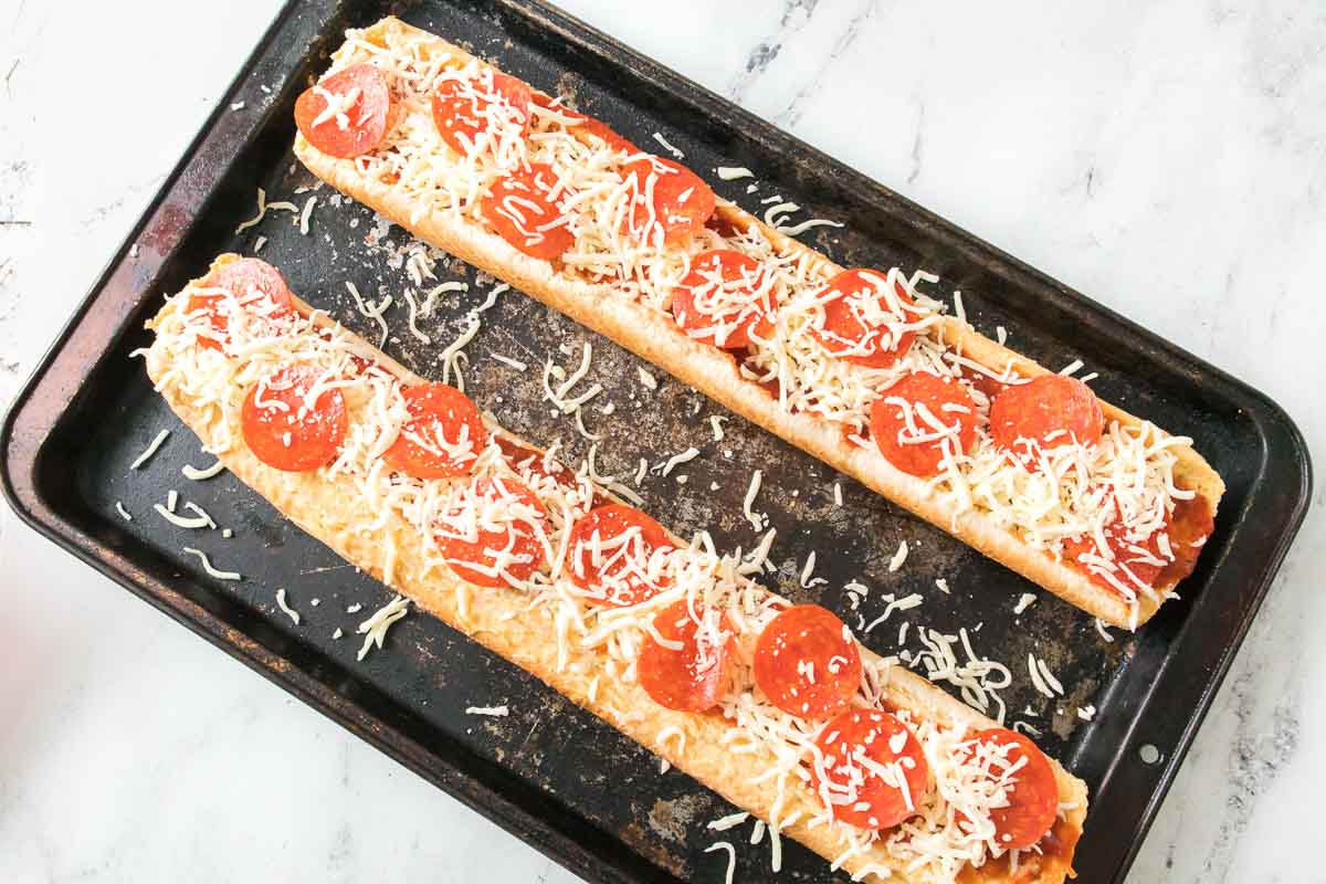 Frozen garlic bread topped with pizza sauce, shredded mozzarella, and pepperoni