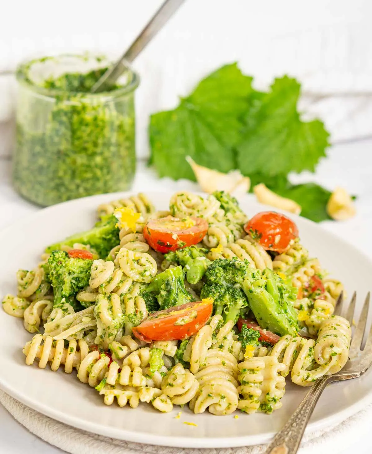Plate of pesto pasta with tomatoes and broccoli