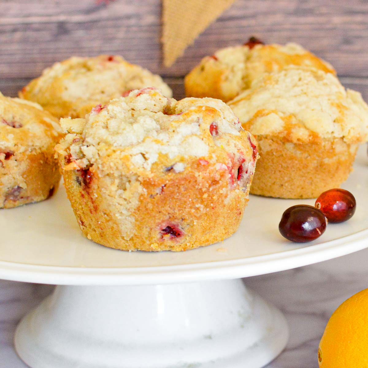 Orange cranberry muffins on a cake stand
