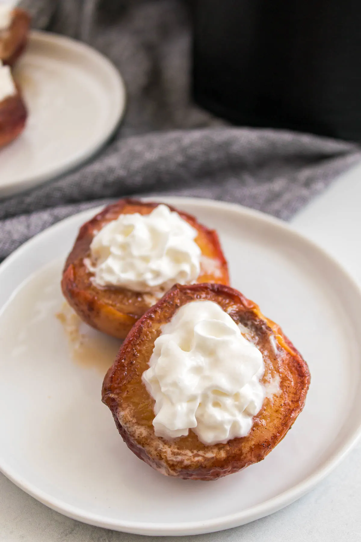 air fried peach halves topped with whipped cream